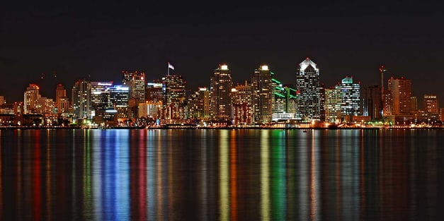 San Diego skyline reflecting on water at night.