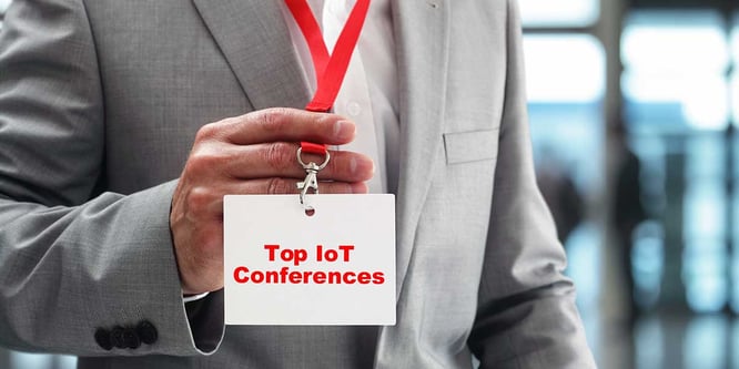 Businessman holding a Top IoT Conferences badge.