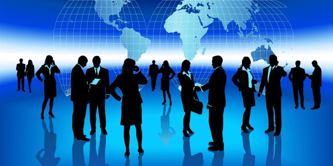 Silhouettes of businesspeople networking in front of a 2D globe.