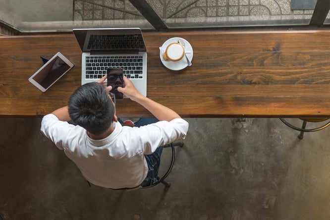 A connected consumer using multiple devices while working from home.