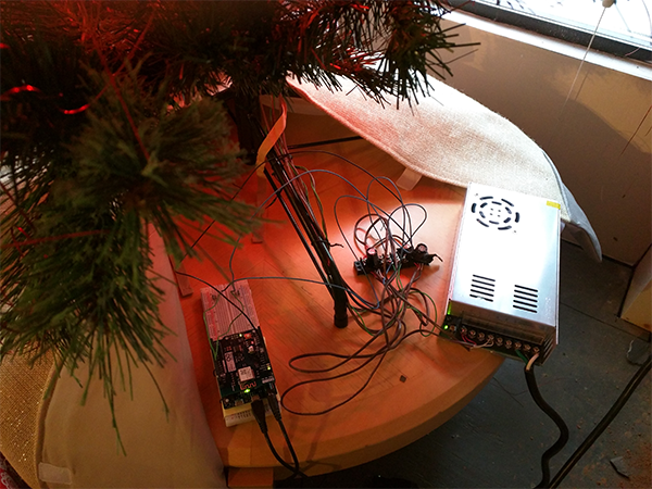 SMAKN DC power supply wired to the Adafruit NeoPixel Digital RGB LED strip on a Christmas tree.