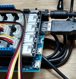Intel Edison hardware with a microphone plugged into the large USB port.