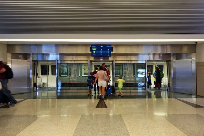 People entering indoor tram at CVG airport and monitor tracking the tram.