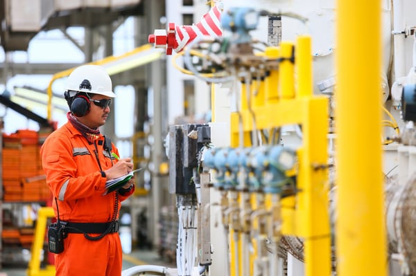 man in industrial environment monitoring equipment