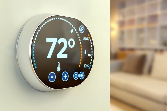 Close up of a smart thermostat on a wall