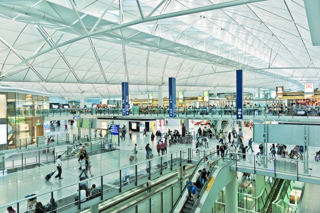 Busy Airport with Large Ceilings and Elevator