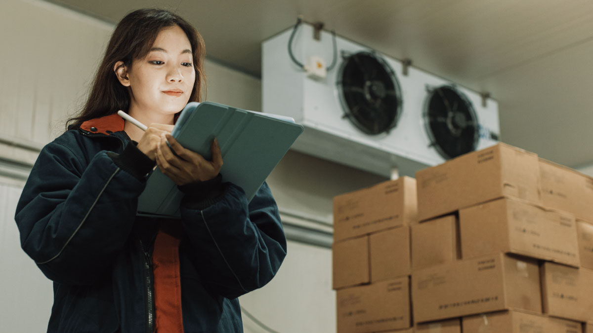 Worker checking inventory on a tablet